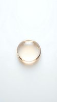 Transparent glass sphere with warm golden light refraction isolated on white background, suitable for skincare, cosmetics, and beauty product design applications.