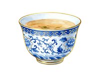 Porcelain teacup with blue and white floral design, gold rim, isolated on white background. Suitable for tableware, home decor, and design projects.