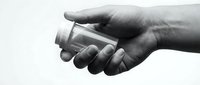Hand holding empty glass jar on white background, isolated for design, packaging mockup, product display, and commercial use.