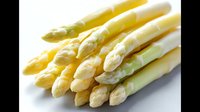 Fresh white asparagus spears arranged in bunch on dark background, raw organic vegetables with tender tips and pale stalks showing natural texture and detail.