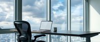 Modern office workspace with black mesh chair, laptop, and cup on desk overlooking city skyline through floor-to-ceiling windows, suitable for business, corporate, and workplace design projects.