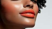 Young African American woman with bright orange lipstick and glowing skin shown in profile against white background, showcasing modern beauty and cosmetic makeup trends.