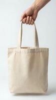 Caucasian male hand holding a blank beige canvas tote bag isolated on white background, mockup for branding and eco design.