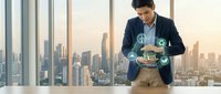 Businessman holding digital tablet with sustainability icons above cityscape view from high-rise office window, representing green business solutions and environmental responsibility.