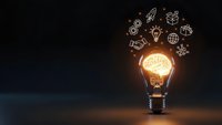 Glowing light bulb with innovation icons floating above on dark background representing creative business ideas and entrepreneurship concepts.
