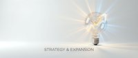 Glowing light bulb with radiating rays symbolizing innovation, strategy and business expansion ideas for corporate growth concepts.