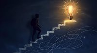 Businessman climbing glowing stairs toward bright lightbulb representing success, innovation and career growth in dark blue background.