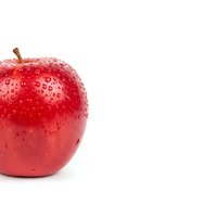 Fresh red apple with water droplets isolated on white background for healthy eating and nutrition concepts.