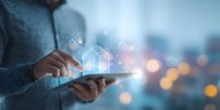 Businessman using digital tablet with glowing financial charts and data visualization against blurred city lights background for investment analysis.
