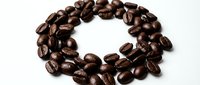 Roasted coffee beans arranged in a circle on white background, suitable for beverage packaging, cafe menus, and coffee product marketing materials.