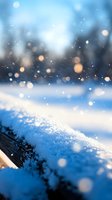 Magical winter scene with falling snow and soft bokeh lights creating dreamy atmosphere. Fresh snowflakes on blurred natural background in cool blue tones.