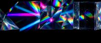 Crystal prisms refracting light into vivid rainbow spectrum on dark background, showcasing optical dispersion and colorful light effects.