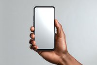 Hand holding modern smartphone with blank white screen mockup for app presentation and mobile interface design projects.