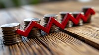 Stacks of coins with red arrow showing upward trend on wooden surface, representing financial growth, investment success and market performance analysis.