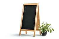 Empty wooden a-frame chalkboard menu stand with decorative potted green plant against white background, isolated restaurant signage for cafe display.