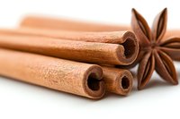 Fresh cinnamon sticks and star anise on white background, aromatic spices macro photography with selective focus and natural lighting for culinary designs.