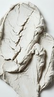 Textured white cream or plaster with organic cracks and ridges, isolated on white background for design, cosmetics, skincare, and artistic projects.