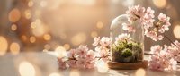 Cherry blossom branches in glass dome with moss, warm bokeh lights creating magical spring atmosphere for home decor and botanical displays.