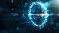 Glowing blue portal with digital particles and light effects on dark background creates futuristic sci-fi atmosphere for technology concepts.