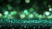 Magical green bokeh lights on dark background with glowing particles and sparkles creating dreamy atmospheric effect. Great for festive designs.
