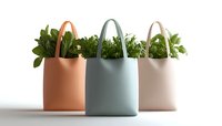 Fresh green plants in pastel colored shopping bags arranged in row on white background, minimalist eco-friendly design concept for sustainable lifestyle.