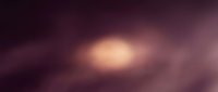 Soft blurred bokeh background with warm golden light center fading to deep purple tones, suitable for overlays and design backdrops.