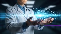Male doctor in white coat holding glowing digital network connections representing modern healthcare technology and medical innovation in futuristic setting.