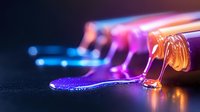 Vibrant liquid spills from glass bottles creating colorful puddles with neon pink and blue glowing effects against dark background, macro photography with selective focus.