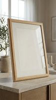 Empty wooden picture frame with white mat on modern console table in bright living room interior for home decor and artwork display mockup.