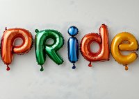 Colorful foil balloon letters spelling PRIDE in rainbow colors against neutral background, celebration decoration for LGBTQ+ events and festivities.