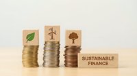Stacked coins with leaf, wind turbine, and tree icons representing sustainable finance and green investment growth.