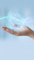 Human hand holding glowing holographic digital interface with transparent panels and light particles on soft blue background for tech concepts.