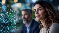 Caucasian businesswoman with curly hair smiling while looking at glowing network visualization, with bearded colleague in background. Technology concept.