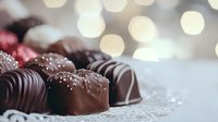 Artisanal chocolate truffles with sea salt garnish on delicate lace doily, soft bokeh lights create romantic mood, close-up view shows rich dark chocolate coating.