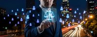 Professional businessman holding digital justice scales hologram with network icons against urban night cityscape background for legal technology concepts.