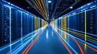Modern data center corridor with glowing server racks and colorful light trails creating futuristic perspective. Network infrastructure with dramatic lighting effects and reflective floor.