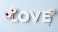 White letters spelling LOVE decorated with pink gerbera daisies and ranunculus flowers on light blue background, romantic minimalist composition for wedding and valentines.
