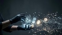 Hands in black gloves reaching toward glowing digital cubes with sparkling light particles on dark background for technology and innovation concepts.