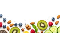 Healthy food frame with fresh fruits, nuts and vegetables on white background. Nutritious organic ingredients for balanced diet and wellness lifestyle.