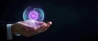 Businessman hand holding glowing purple energy sphere with futuristic holographic rings on dark background for technology and innovation concepts.