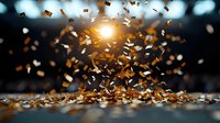 Golden confetti explosion with bright light burst against dark background, creating magical celebratory atmosphere with flying metallic particles and bokeh effect.