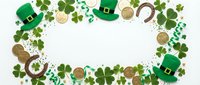 St. Patrick's Day frame with green shamrocks, leprechaun hats, gold coins and horseshoes on white background for festive holiday designs and decorations.