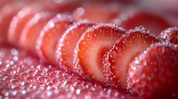 Sliced fresh strawberries covered in sparkling sugar crystals arranged in a row with soft focus bokeh effect creating dreamy food photography composition.