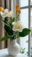 White ceramic vase with cream roses and orange tulips on windowsill in bright natural light for home decor and interior design projects.