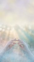 Cupped hands reaching upward in ethereal light with soft pastel colors and magical sparkles creating spiritual atmosphere for meditation and healing concepts.