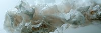 Crumpled transparent plastic bags and wrapping materials scattered on white surface creating texture pattern for environmental awareness concepts.