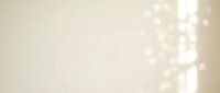 Soft beige background with warm bokeh lights creating elegant atmosphere for luxury branding and wedding designs.