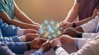 Healthcare teamwork concept with medical professionals joining hands around glowing digital health icons representing collaborative patient care and unity.