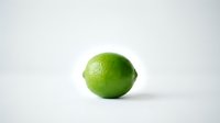 Fresh green lime isolated on white background, ready for food and beverage design, packaging, and culinary content.