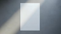 Blank white paper sheet on gray surface with natural shadow overlay creating minimalist mockup template for branding and design projects.